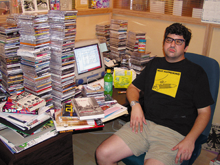 Dana Harris spends a Friday night cataloging his CD collection on a computer spreadsheet.